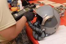 An Airman from the 5th Operations Support Squadron aircrew flight equipment section tests a helmet’s microphone at Minot Air Force Base, N.D., July 26, 2016. The microphones are tested to ensure pilots can hear the correct frequencies and the device works properly. (U.S. Air Force photo/Airman 1st Class Jessica Weissman)