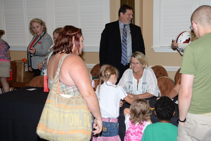A military family speaks to a school representative during the educational summit held at the Town and Country Grand Ballroom aboard Marine Corps Logistics Base Albany, July 21.  The summit was an opportunity for military families to listen to and ask questions of area school representatives about their individual school systems.
