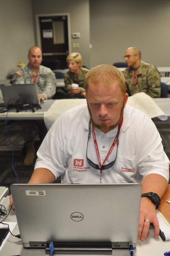 Mission Specialist Jay Marlow feeds data into ENGlink, a program used to track equipment and staff actions, during a regional power mission exercise conducted July 20 at the Federal Emergency Management Agency Distribution Center in Atlanta, Georgia. 