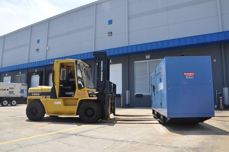 A member of the Federal Emergency Management Agency's Emergency Support Function transports a generator during an interagency regional power mission exercise held at the FEMA Distribution Center in Atlanta, Georgia July 20. The team replicated a temporary emergency power deployment in response to a simulated natural disaster. The three-day training and exercise tested the unit’s ability to execute temporary emergency power operations. 