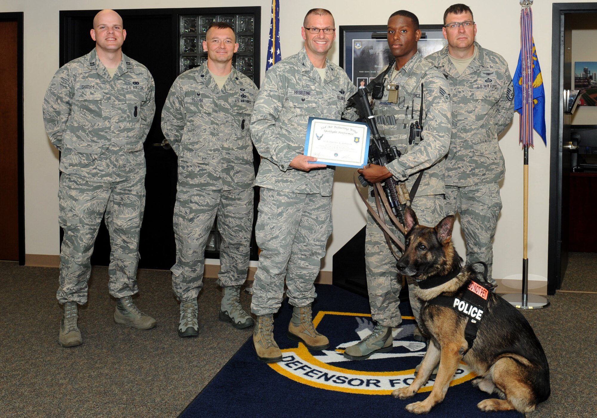 Senior Airman Charles Johnson, 22nd Security Forces Squadron military working dog handler, poses with Col. Phil Hesseltine, 22nd Air Refueling Wing vice commander, June 7, 2016, at McConnell Air Force Base, Kan. Johnson received the spotlight performer for the week of May 16-20. (U.S. Air Force photo/Senior Airman David Bernal Del Agua)