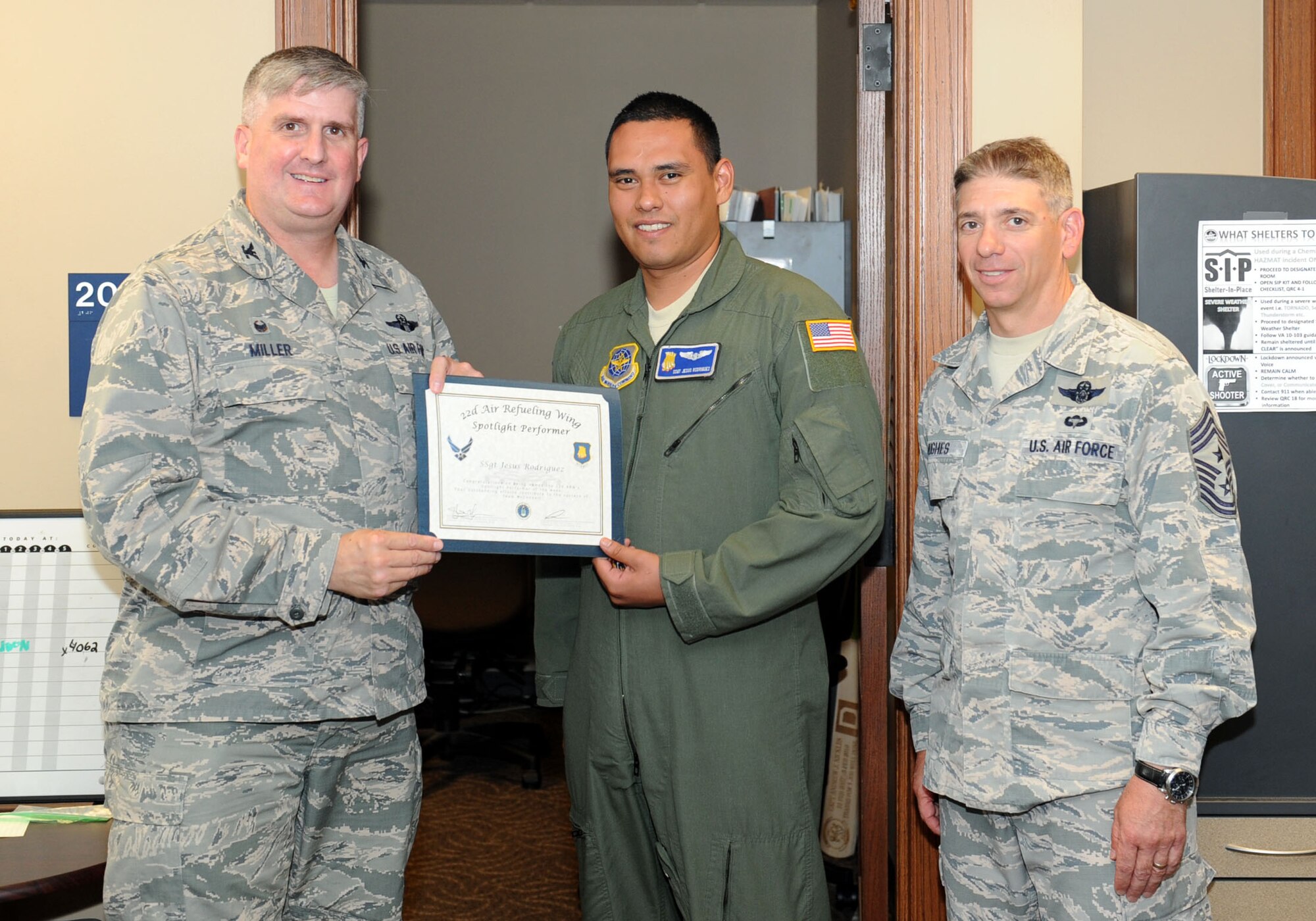 Staff Sgt. Jesus Rodriguez, 22nd Operations Group unit deployment manager and boom operator, poses with Col. Albert Miller, 22nd Air Refueling Wing commander, and Chief Master Sgt. Shawn Hughes, 22nd ARW command chief, July 19, 2016, at McConnell Air Force Base, Kan. Rodriguez received the spotlight performer for the week of May 23-27. (U.S. Air Force photo/Senior Airman David Bernal Del Agua)