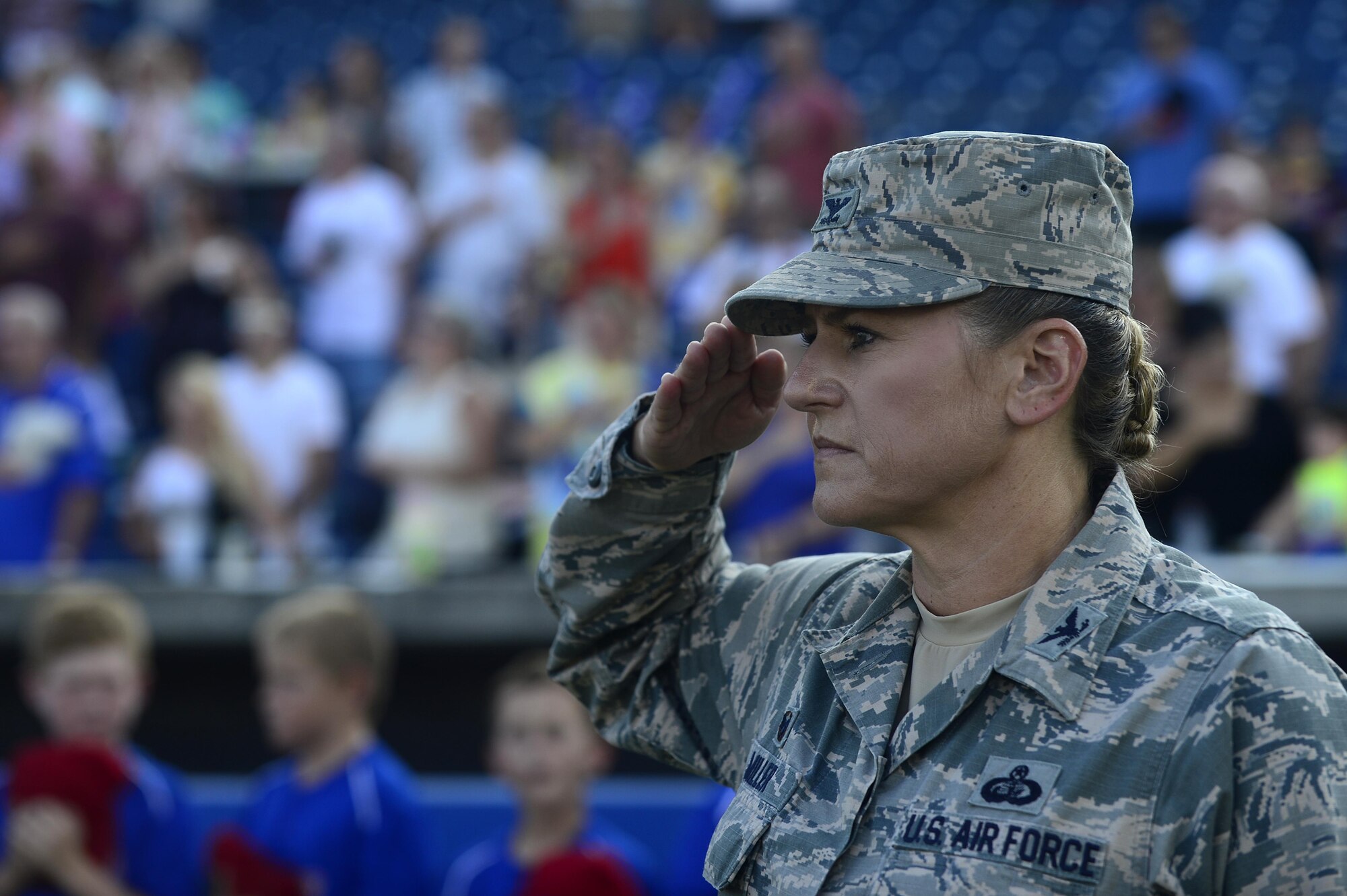 U.S. Air Force Col. Caroline Miller, 633rd Air Base Wing commander, renders a salute as the Air Combat Command Heritage of America Band plays “The Star-Spangled Banner” at the Norfolk Tides Air Force Appreciation Night baseball game in Norfolk, Va., July 23, 2016. The event was held to honor Joint Base Langley-Eustis in celebration of 100 years of Air Power over Hampton Roads at Langley Air Force Base. (U.S. Air Force photo by Airman 1st Class Kaylee Dubois)
