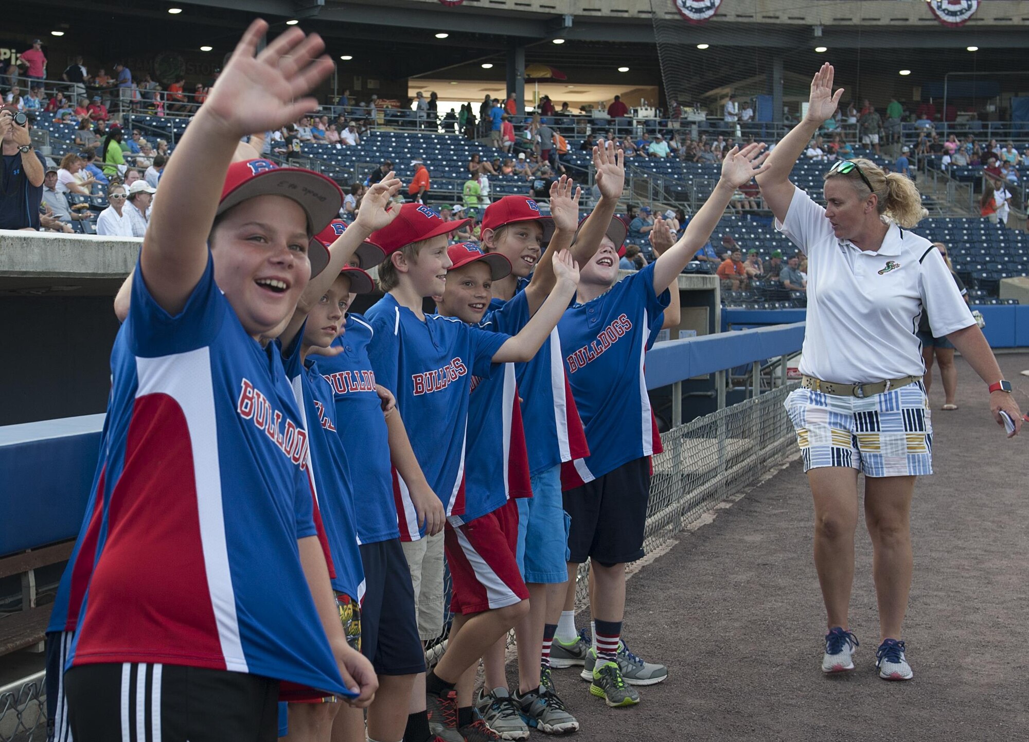 Norfolk Bulldogs Little League baseball team players participate in a meet-and-greet with players from the Norfolk Tides minor league baseball team at the Norfolk Tides Air Force Appreciation Night baseball game in Norfolk, Va., July 23, 2016. Each member of the Bulldogs teamed-up with a Tides player on the field at their respective positions for the opening remarks. (U.S. Air Force photo by Airman 1st Class Kaylee Dubois)