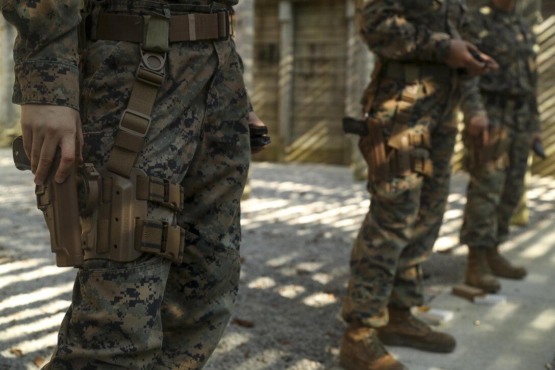U.S. Marines assigned to the Female Engagement Team, 22nd Marine Expeditionary Unit (MEU), hold ammunition during a pistol qualification course at Camp Lejeune, N.C., April 26, 2016. Marines with the 22nd MEU participated in a course of fire for pistol qualification in order to improve and maintain combat readiness. 