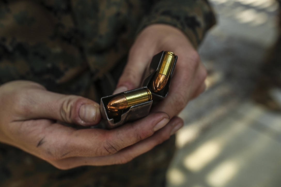 A U.S. Marine assigned to the Female Engagement Team, 22nd Marine Expeditionary Unit (MEU), holds loaded magazines during a pistol qualification course at Camp Lejeune, N.C., April 26, 2016. Marines with the 22nd MEU participated in a course of fire for pistol qualification in order to improve and maintain combat readiness. 