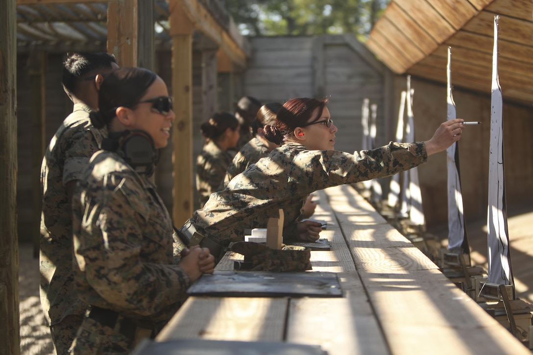 U.S. Marines assigned to the Female Engagement Team, 22nd Marine Expeditionary Unit (MEU), check their tagets for impact during a pistol qualification course at Camp Lejeune, N.C., April 26, 2016. Marines with the 22nd MEU participated in a course of fire for pistol qualification in order to improve and maintain combat readiness. 