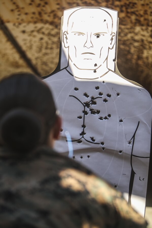 A U.S. Marine assigned to the Female Engagement Team, 22nd Marine Expeditionary Unit (MEU), check her tagets for hits during a pistol qualification course at Camp Lejeune, N.C., April 26, 2016. Marines with the 22nd MEU participated in a course of fire for pistol qualification in order to improve and maintain combat readiness. 