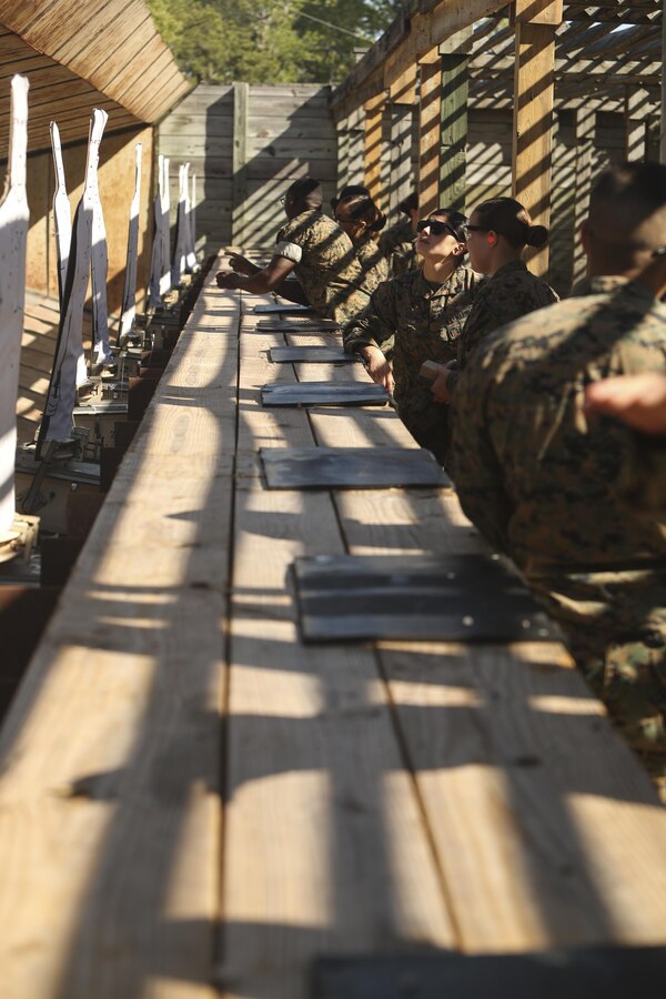 U.S. Marines assigned to the Female Engagement Team, 22nd Marine Expeditionary Unit (MEU), check their targets for impact during a pistol qualification course at Camp Lejeune, N.C., April 26, 2016. Marines with the 22nd MEU participated in a course of fire for pistol qualification in order to improve and maintain combat readiness. 