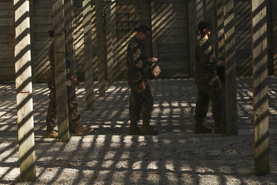 U.S. Marines assigned to the Female Engagement Team, 22nd Marine Expeditionary Unit (MEU), leave the firing line during a pistol qualification course at Camp Lejeune, N.C., April 26, 2016. Marines with the 22nd MEU participated in a course of fire for pistol qualification in order to improve and maintain combat readiness. 