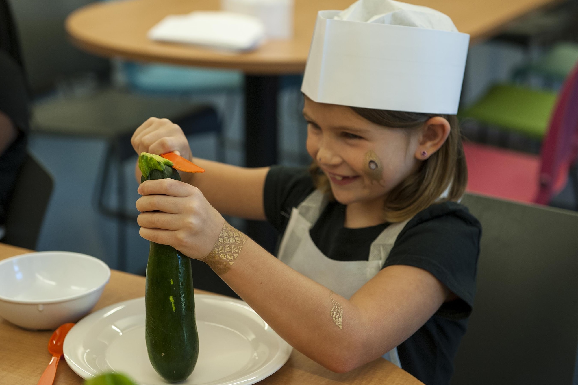 Isabella, daughter of U.S. Air Force Master Sgt. Jennifer Smith, 23d Force Support Squadron manpower and organization superintendent, cuts a zucchini during a youth cooking camp, July 26, 2016, at Moody Air Force Base, Ga. During the camp, children learned how to cook from various recipes and practiced proper sanitation and food handling techniques. (U.S. Air Force photo by Airman 1st Class Lauren M. Hunter)