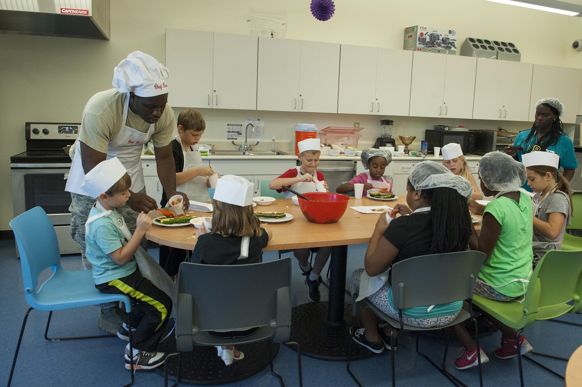 Participants prepare food during a youth cooking camp, July 26, 2016, at Moody Air Force Base, Ga. During the week-long camp, children learned how to incorporate healthy options into their daily diet. (U.S. Air Force photo by Airman 1st Class Lauren M. Hunter)