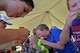 Team Shaw children participate in a watermelon eating contest during the Exceptional Family Member Program Kid’s Jamboree at Shaw Air Force Base, S.C., July 27, 2016. Parents and children had the opportunity to participate in bounce house activities, various informational booths and standard health screenings. (U.S. Air Force photo by Airman 1st Class Christopher Maldonado)