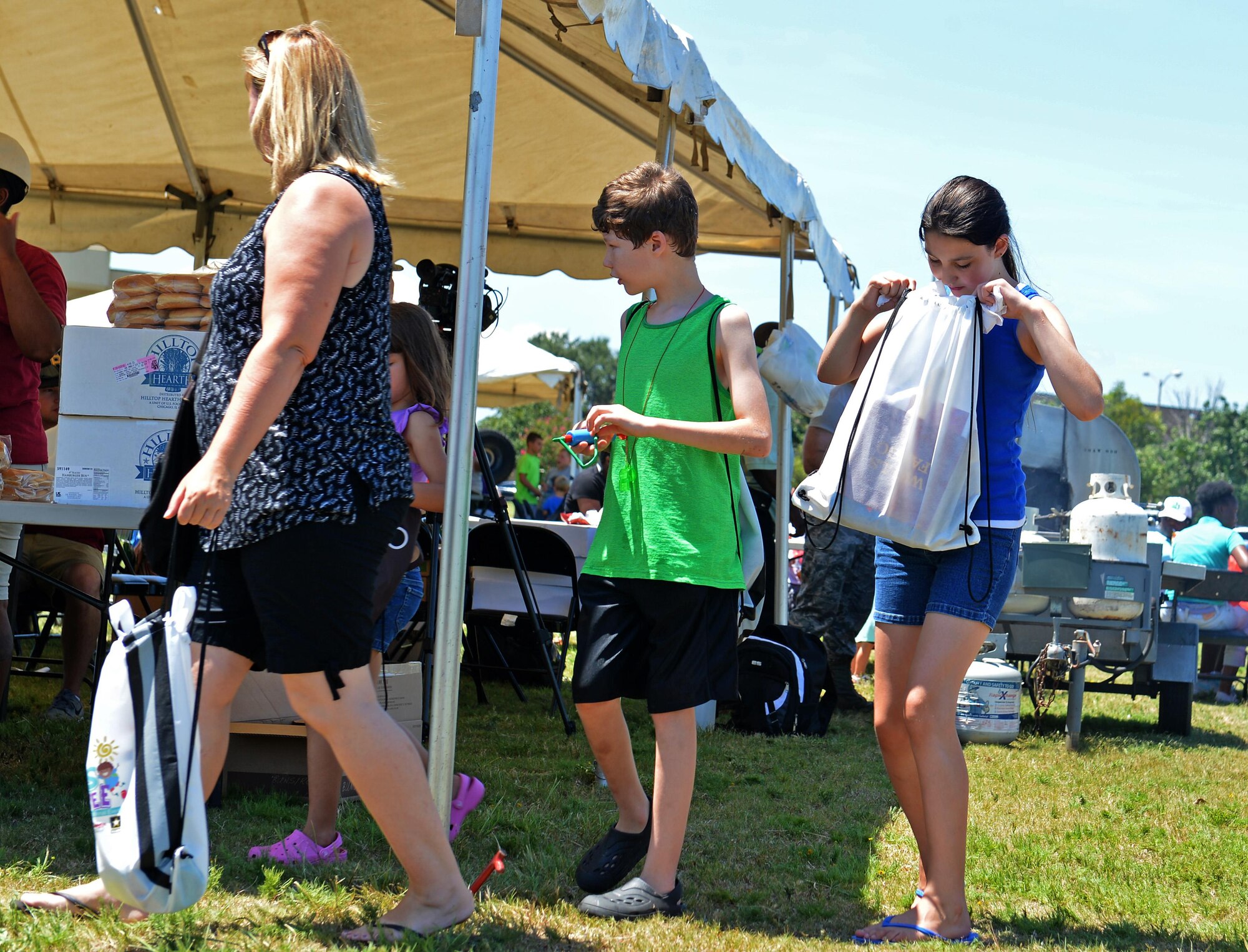 A Team Shaw member looks inside a backpack during the Exceptional Family Member Program Kid’s Jamboree at Shaw Air Force Base, S.C., July 27, 2016. Team Shaw children were treated to various school items, and free food and drinks throughout the event. (U.S. Air Force photo by Airman 1st Class Christopher Maldonado)