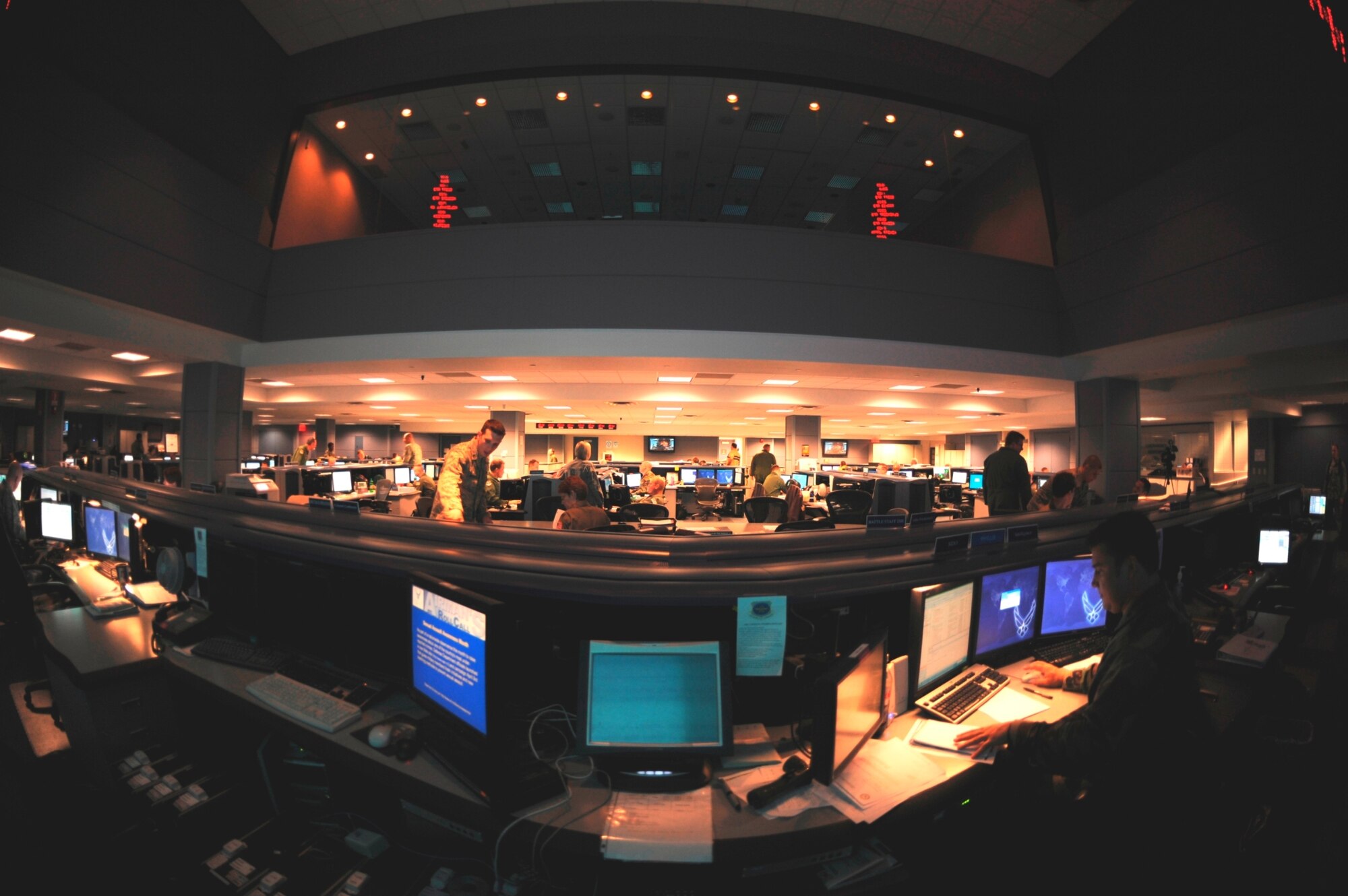 Members of the 618th Air Operations Center coordinate with aircrews, maintenance personnel and aerial porters around the world from their operations floor at Scott Air Force Base, Illinois.  One of their planners researched and found a way to more accurately predict fuel load requirements, thus eliminating the need to carry extra fuel for contingencies--potentially saving millions of dollars for the Air Force.