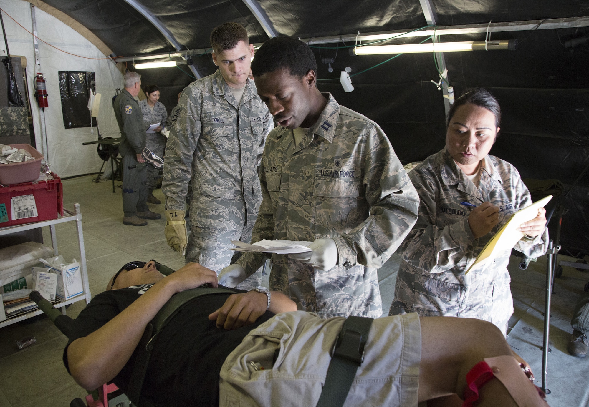Staff Sgt. Christopher Knoll, Capt. Jermetrius Williams and Master Sgt. Maecolleen Balcobero, 349th Medical Squadron, 349th Medical Squadron, evaluate a mock casualty during a live-shooter, mass casualty exercise at Travis Air Force Base, Calif., July 23, 2016. The PATRIOT WYVERN exercises are hands-on, bi-annual events conducted by the 349th Air Mobility Wing designed to hone combat skills and improve organizational interoperability. The code name “Patriot” is common to many Air Force Reserve led exercises, such as Operation PATRIOT EXPRESS. The wyvern name derives from the mythical winged creature found on the 349th AMW's unit crest. This weekend's PATRIOT WYVREN included participation by Airmen from the 349th AMW, 60th Medical Group, and Soldiers from the 238th Transportation Company. (U.S. Air Force photo by Lt. Col. Robert Couse-Baker)