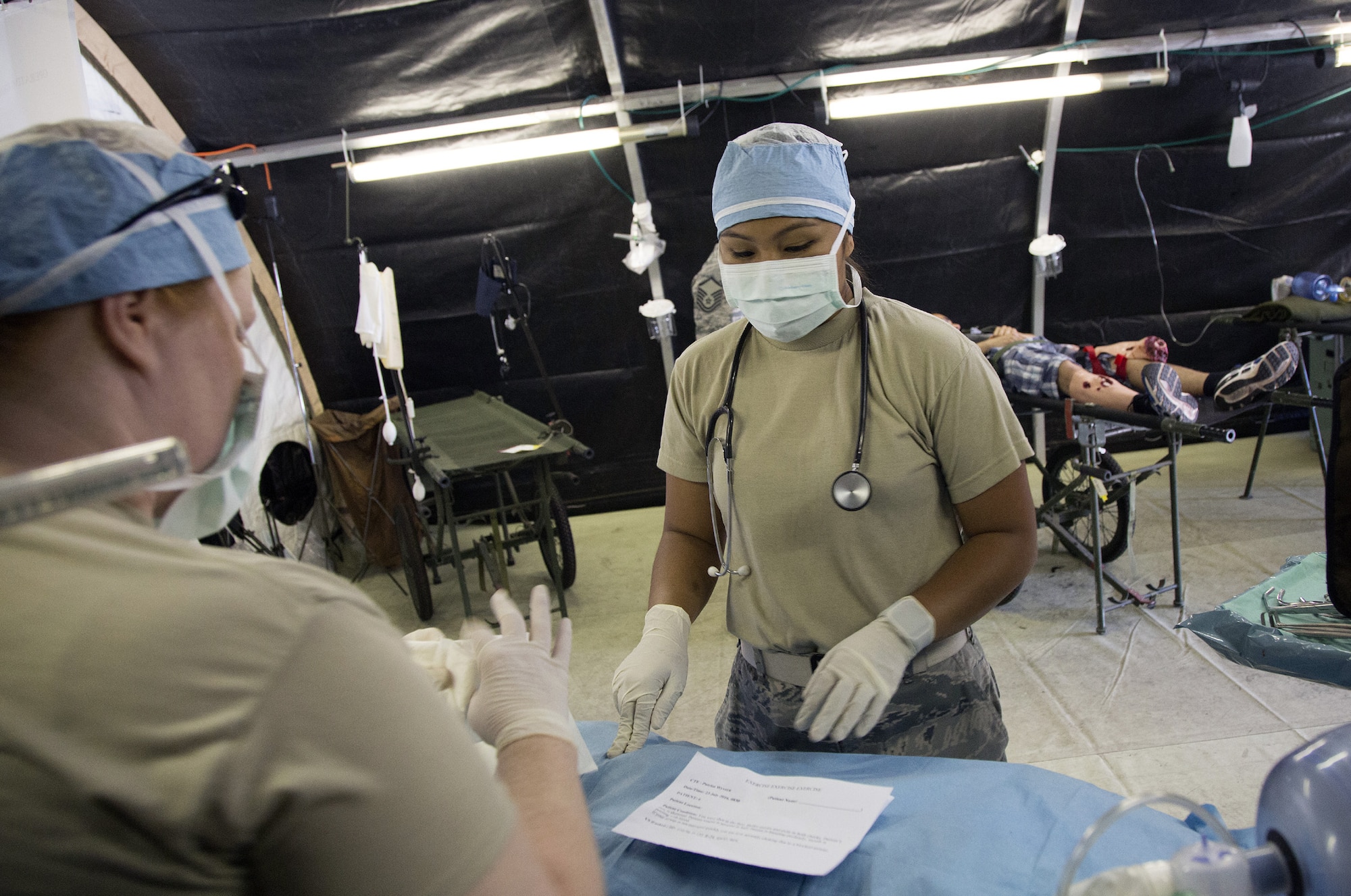 Citizen Airmen from the 349th Medical Squadron prepare a surgical suite for a mock casualty during a live-shooter, mass casualty exercise at Travis Air Force Base, Calif., July 23, 2016. The PATRIOT WYVERN exercises are hands-on, bi-annual events conducted by the 349th Air Mobility Wing designed to hone combat skills and improve organizational interoperability. The code name “Patriot” is common to many Air Force Reserve led exercises, such as Operation PATRIOT EXPRESS. The wyvern name derives from the mythical winged creature found on the 349th AMW's unit crest. This weekend's PATRIOT WYVREN included participation by Airmen from the 349th AMW, 60th Medical Group, and Soldiers from the 238th Transportation Company. (U.S. Air Force photo by Lt. Col. Robert Couse-Baker)