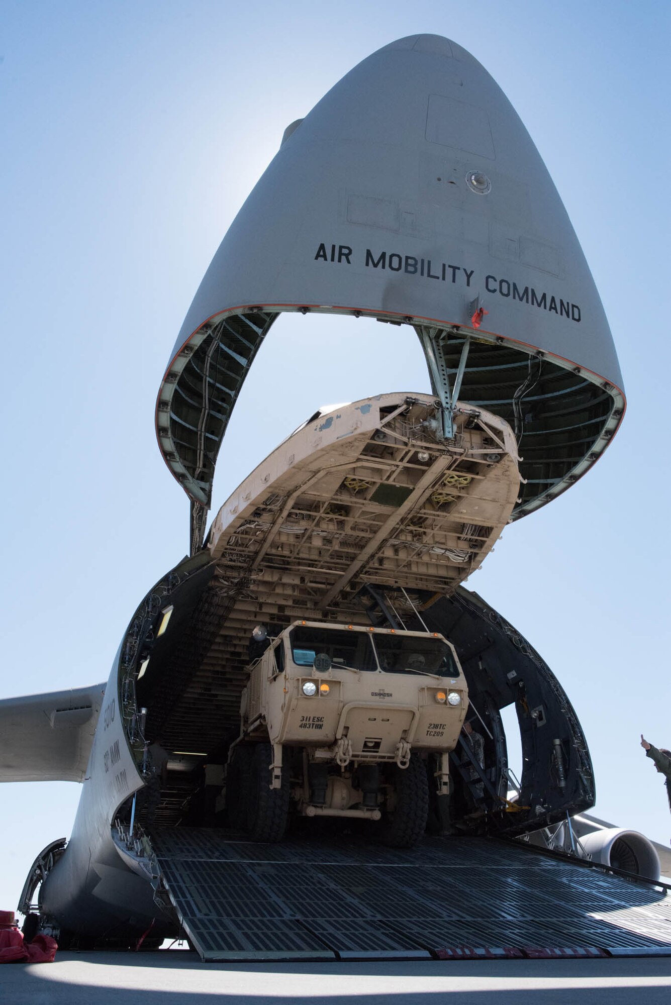 An Army Reserve load handling system exits a C-5M Super Galaxy at Travis Air Force base, Calif., during Exercise Patriot Wyvern. Reservists from the 349th Air Mobility Wing and the 238th Transportation Company joined forces July 23, 2016 to share air transportation skills during the joint training event. The exercise which involved multiple active duty, Air Force Reserve and Army Reserve units, helped Airmen and Soldiers hone their job skills and learn how to work efficiently together under difficult circumstances. The 238th TC is stationed at nearby Military Ocean Terminal Concord (U.S. Air Force photo by Ken Wright)