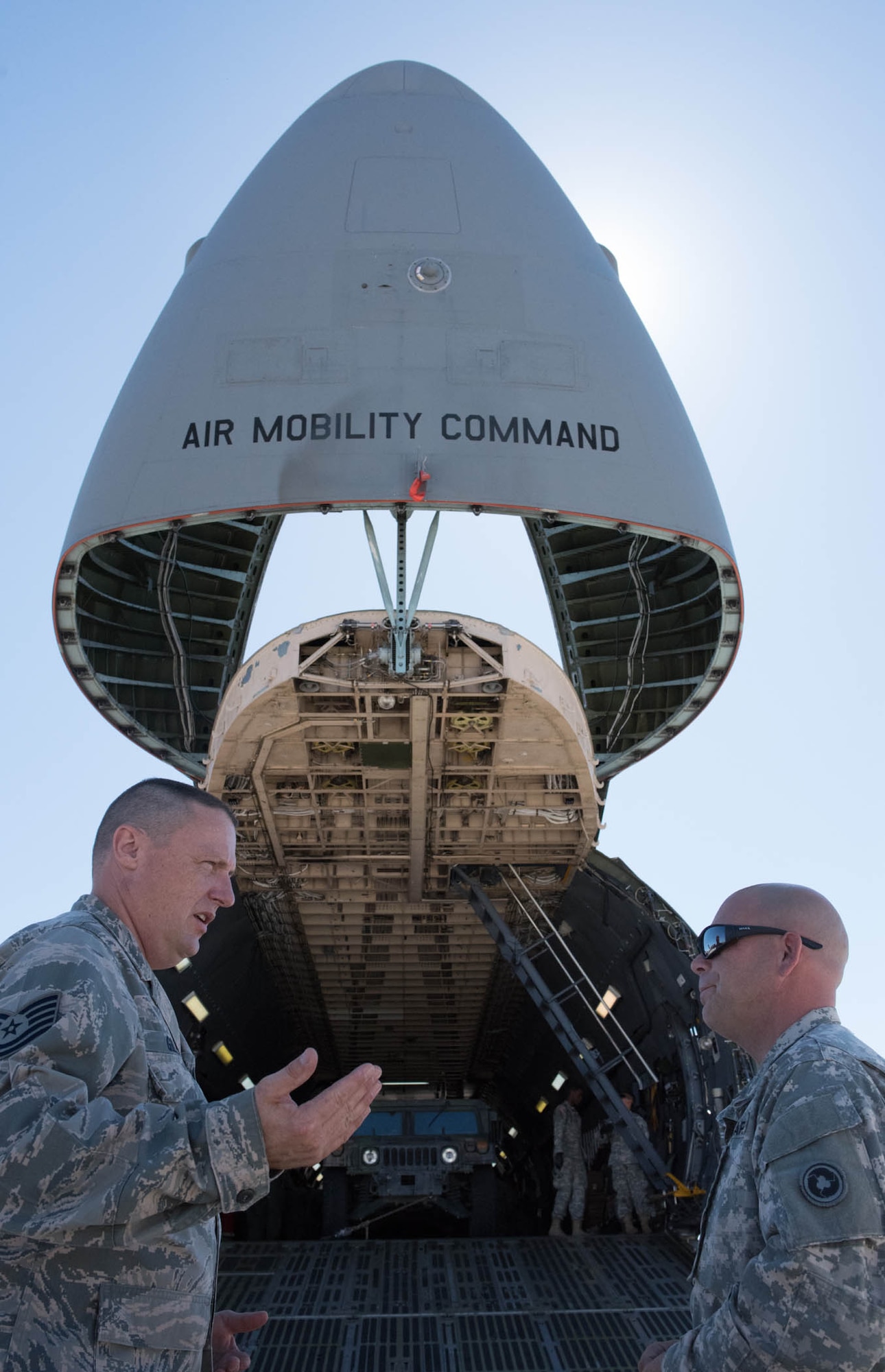 Technical Sgt. Kevin Gilles, 82nd Aerial Port Squadron, and Sgt. Scott Connelly, 238th Transportation Company training NCO, discuss the benefits of having their unit members work together to strengthen their job skills at Travis Air Force Base, Calif. The Air Force and Army reservists coordinated for three months to develop a July 23, 2016 training event that taught soldiers how to load and secure heavy equipment aboard the C-5M Super Galaxy.
Gilles, commented that something as simple as teaching Airmen and Soldiers to understand each service’s equipment nomenclatures benefits everyone, especially during quick deployments when they have to move tons of equipment and supplies quickly, safely and efficiently. (U.S. Air Force photo by Ken Wright)