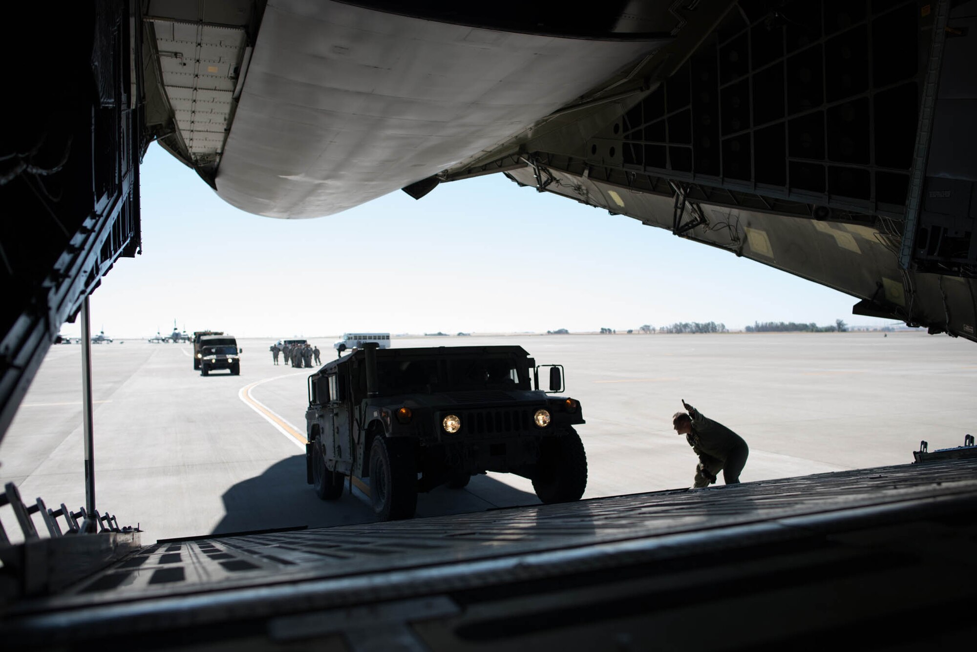 An Army Reserve HUMVEE is guided into a C-5M Super Galaxy at Travis Air Force base, Calif., during Exercise Patriot Wyvern. Reservists from the 349th Air Mobility Wing and the 238th Transportation Company joined forces July 23, 2016 to share air transportation skills during the joint training event. The exercise which involved multiple active duty, Air Force Reserve and Army Reserve units, helped Airmen and Soldiers hone their job skills and learn how to work efficiently together under difficult circumstances. The 238th TC is stationed at nearby Military Ocean Terminal Concord (U.S. Air Force photo by Ken Wright)