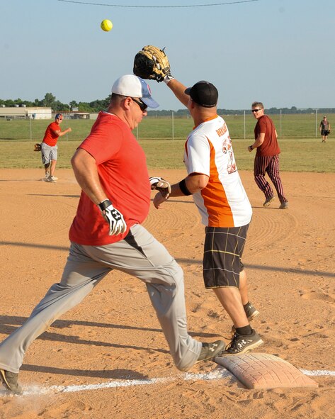 There is a close play at first between the runner Christopher Hall, Air Force Global Strike Command softball team catcher, and the first baseman David Demarest, 2nd Maintenance Squadron softball team, in the top of the second inning at Barksdale Air Force Base, La., July 21, 2016. AFGSC would not score this inning. (U.S. Air Force photo/Airman 1st Class Stuart Bright)