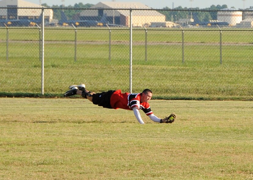 Cristopher Sage, Air Force Global Strike Command softball team centerfielder, lays out for a catch in the bottom of the second inning at Barksdale Air Force Base, La., July 21, 2016. Sage scored three runs in the game and hit a homerun in the third inning. (U.S. Air Force photo/Airman 1st Class Stuart Bright)