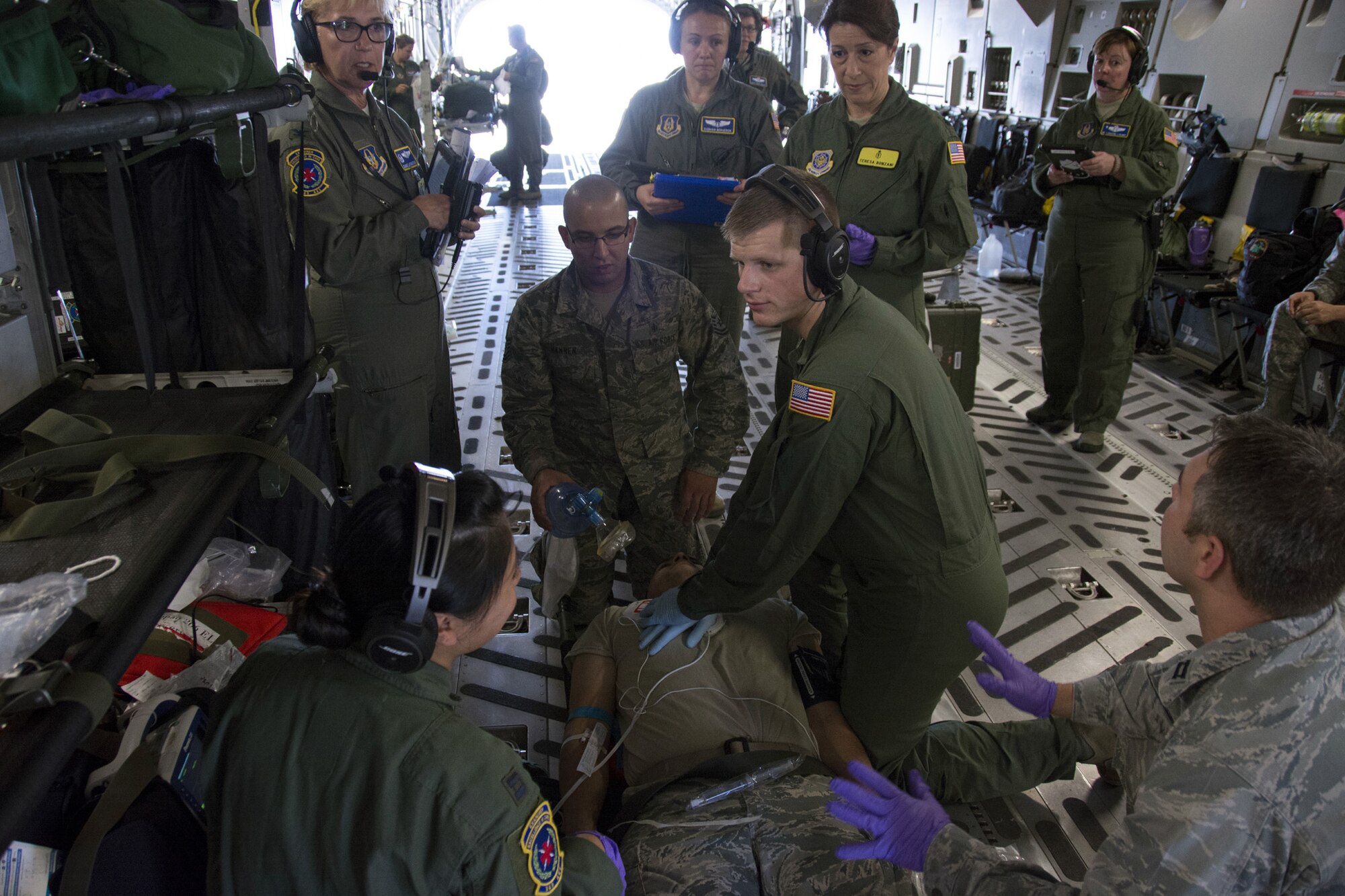 Senior Airman Cody Parker, an air evacuation technician with the 349th Aeromedical Evacuation Squadron, provides cardiopulmonary resuscitation to a simulated gunshot victim who went into cardiac arrest during Exercise Patriot Wyvern, July 23,2016. The 349th Aeromedical Staging Squadron, 349th Medical Squadron and the 349th Aeromedical Evacuation Squadron practiced in-flight emergency and evacuation processes during the training event at Travis Air Force base, Calif.
Patriot Wyvern is a hands-on, bi-annual event conducted by the 349th AMW, and designed to hone combat skills and improve organizational interoperability. (U.S. Air Force photo by Senior Airman Sajjan Singh)
