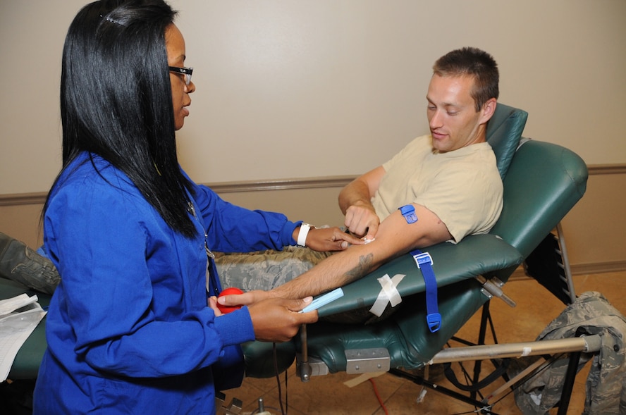 Lanicece Johnson, Life Share phlebotomist, prepares the arm of Staff Sgt. Brandon Allen, 2nd Aircraft Maintenance Squadron supply liaison, for a blood donation at Hoban Hall on Barksdale Air Force Base, La., July 25, 2016. The Life Share blood drive and marrow registry was held on behalf of Tech. Sgt. Javon Lee’s son, Micah Johnson, who was diagnosed with severe aplastic anemia, a blood disease. (U.S. Air Force photo/Airman Alexis C. Frost)