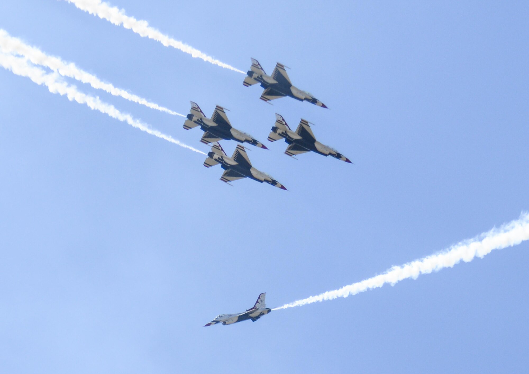 U.S. Air Force Thunderbirds pass one another in a fast-paced aerial stunt during Cheyenne Frontier Days, July 27, 2016, in Cheyenne, Wyo. The Thunderbirds fly closely in formation and make close passes at intense speeds during their shows. (U.S. Air Force photo by Senior Airman Jason Wiese)