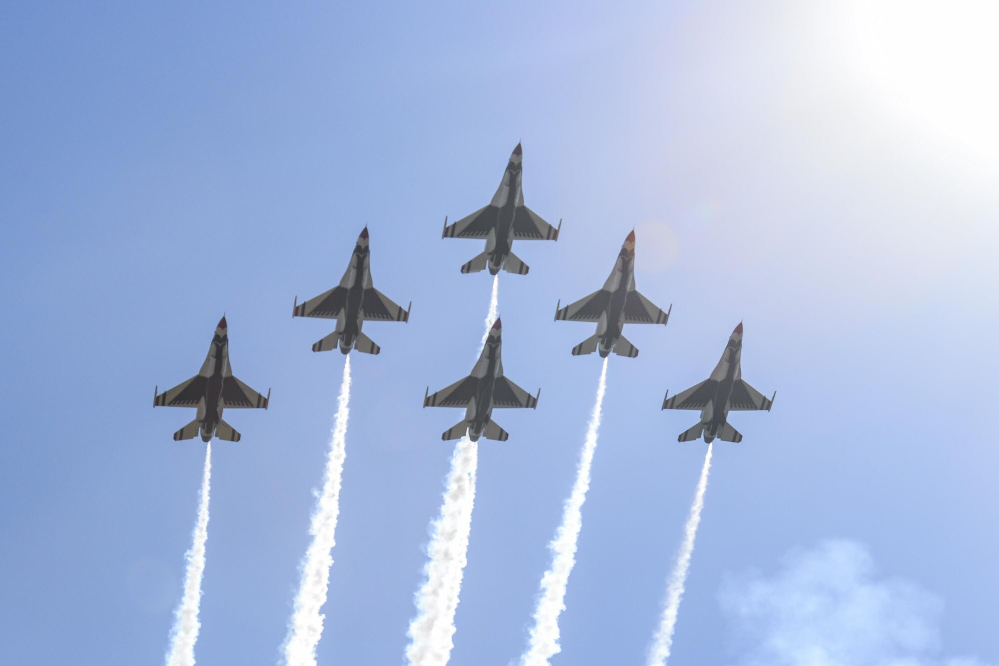 U.S. Air Force Thunderbirds climb high into the sun July 27, 2016, during Cheyenne Frontier Days, July 27, 2016, in Cheyenne, Wyo. The Thunderbirds fly in formation and perform aerial maneuvers to showcase their skills and precision. (U.S. Air Force photo by Senior Airman Jason Wiese)