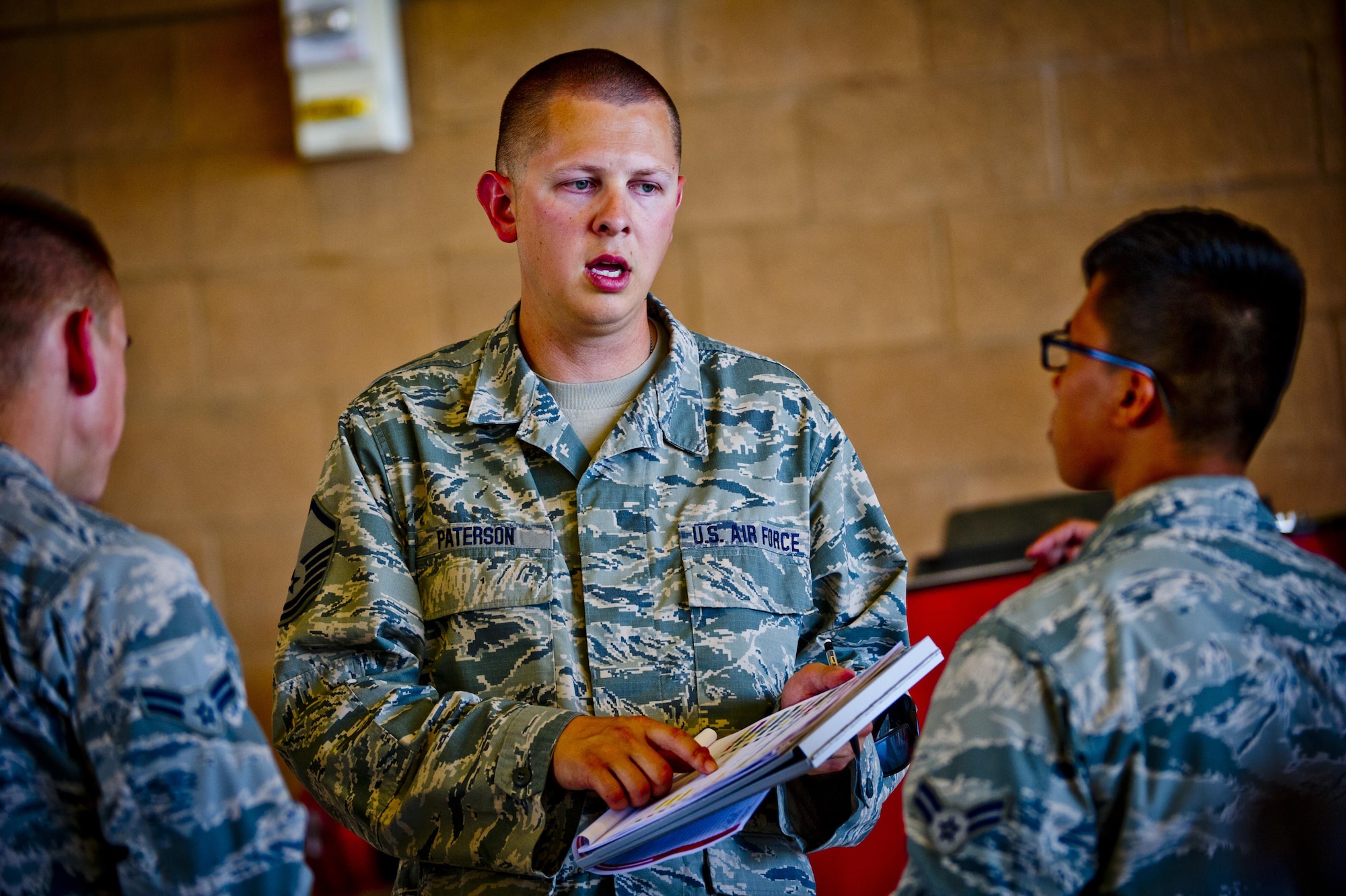 Master Sgt. Michael Paterson, 926th Aircraft Maintenance Squadron flightline expeditor, discusses crew chief assignments with fellow Airmen during Red Flag 16-3, July 13, 2016 at Nellis Air Force Base, Nev. The 926th Wing has crew chiefs working directly in the ground-handling and servicing of the appropriate aircrafts they’re assigned to at Nellis AFB. (U.S. Air Force photo/Senior Airman Brett Clashman)