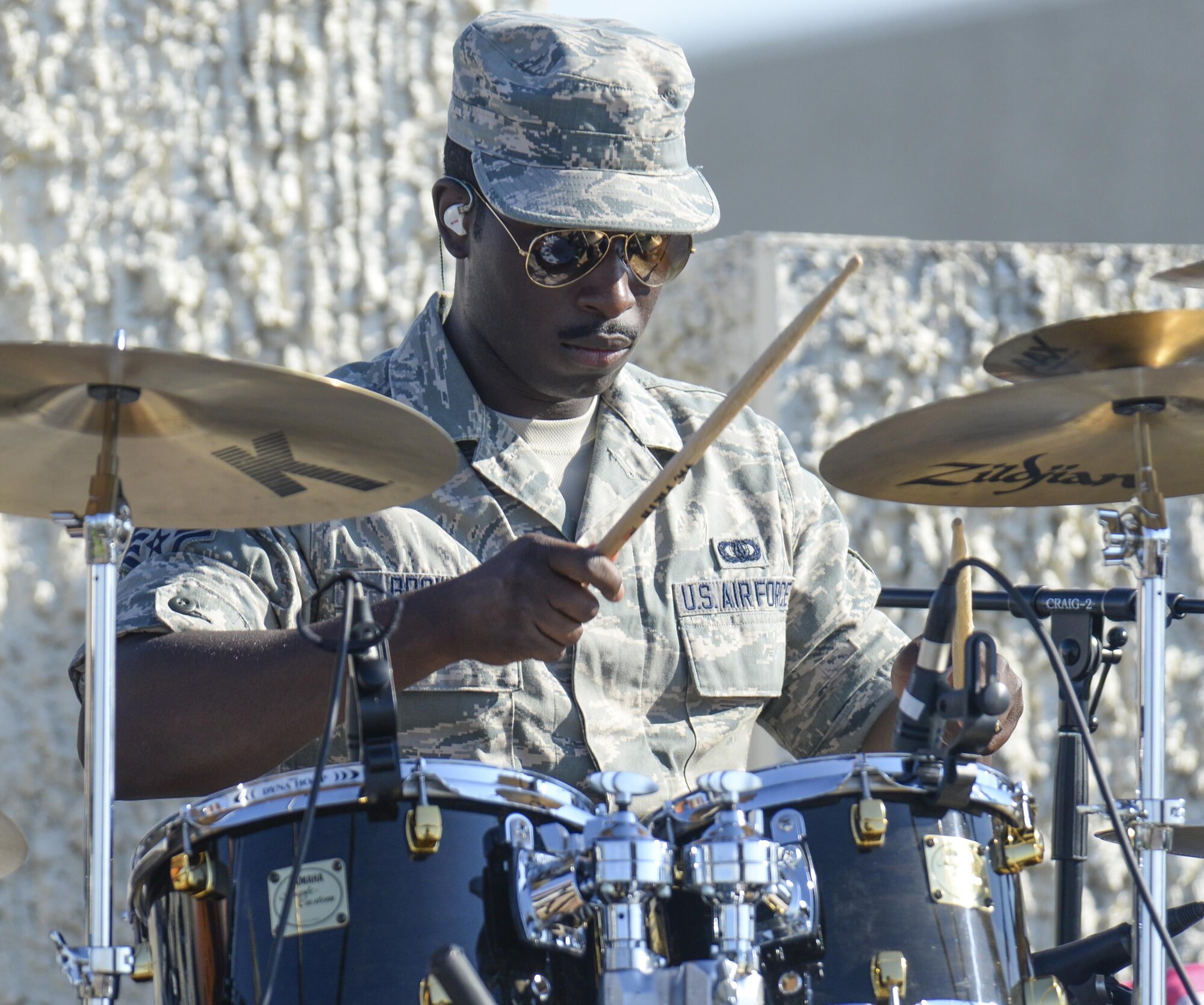 Staff Sgt. Quincy Brown, Air Force Academy Band Blue Steel drummer, plays along with his bandmates prior to the U.S. Air Force Thunderbirds air show July 27, 2016, during Cheyenne Frontier Days, in Cheyenne, Wyo. The Thunderbirds are an Air Combat Command unit composed of eight pilots, including six demonstration pilots, four support officers, three civilians and more than 130 enlisted personnel performing in 25 career fields. (U.S. Air Force photo by Senior Airman Jason Wiese)