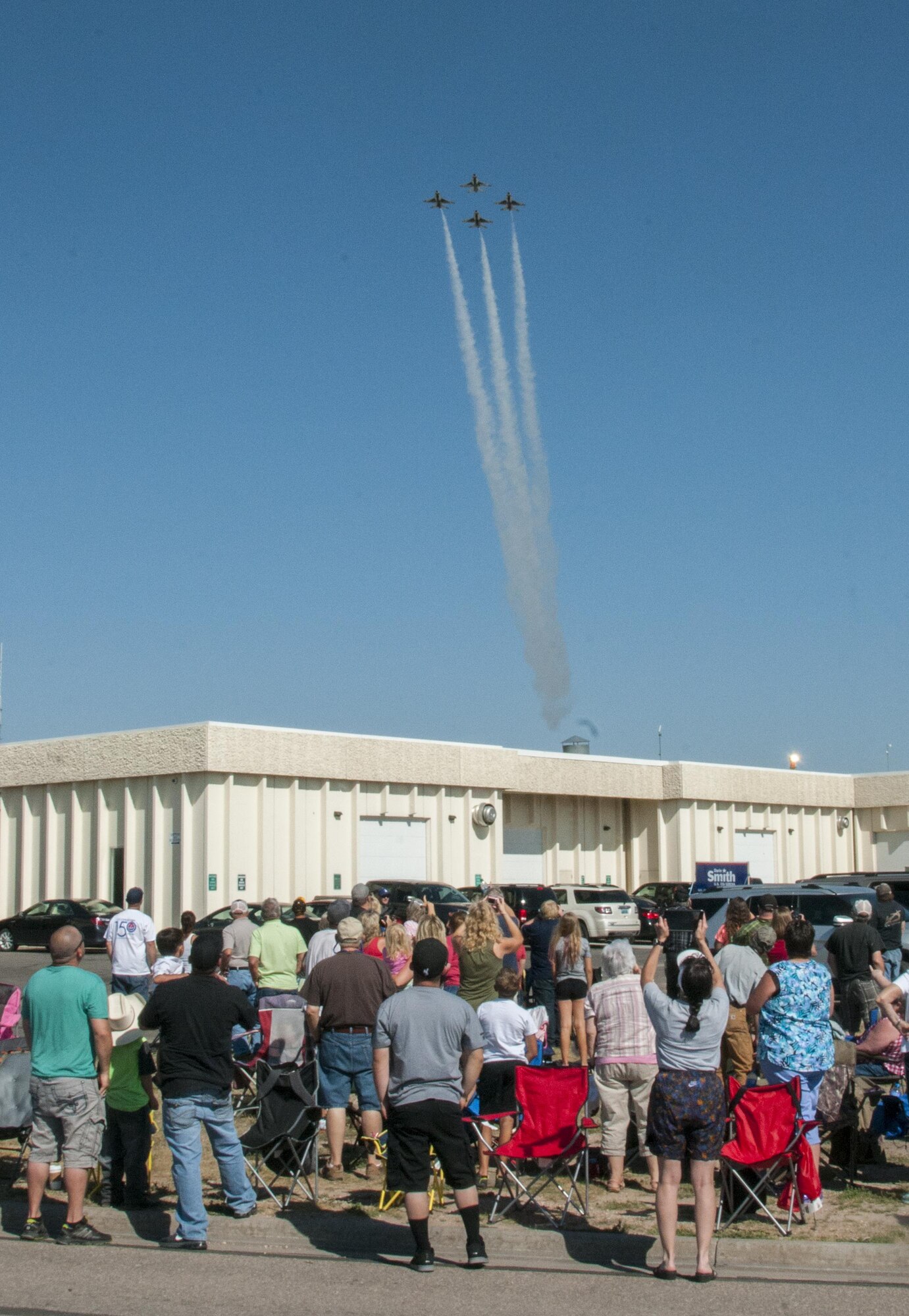Cheyenne residents and visitors watch the U.S. Air Force Thunderbirds make their air show entrance during Cheyenne Frontier Days, July 27, 2016, in Cheyenne, Wyo.  The Thunderbirds made their civilian air show debut at CFD in 1953. (U.S. Air Force photo by Senior Airman Jason Wiese)