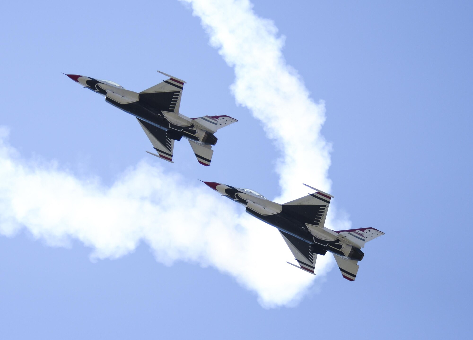 Two U.S Air Force Thunderbirds roar by during Cheyenne Frontier Days, July 27, 2016, in Cheyenne, Wyo. Thunderbirds air shows are the culmination of hundreds of hours of training, maintenance, preparation and practice. (U.S. Air Force photo by Senior Airman Jason Wiese)