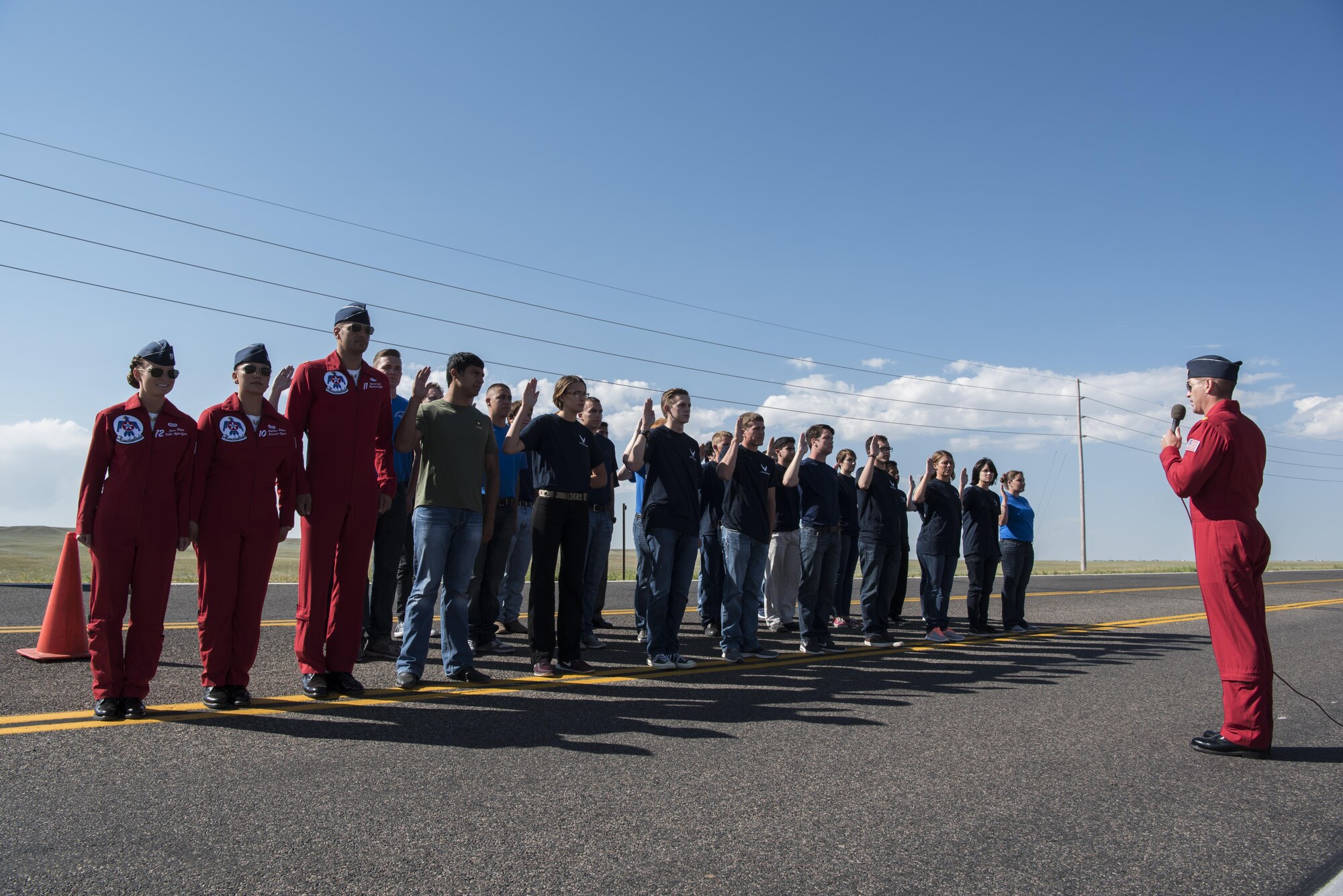 Maj. Kevin Walsh, U.S. Air Force Thunderbirds Operations officer and Thunderbirds #7 pilot, reads the enlisted oath to 28 men and women before a Thunderbirds air show, July 27, 2016 in Cheyenne Wyoming. The oath of enlistment is a military tradition and is recited by those who enlist or re-enlist in the Armed Forces of the United States. (U.S. Air Force photo by Staff Sgt. Christopher Ruano)