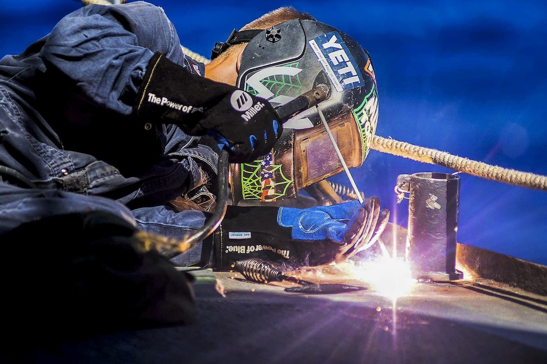 Navy Petty Officer 3rd Class Andrew Workman welds a stanchion mount in place aboard the guided-missile cruiser USS Mobile Bay during Rim of the Pacific 2016 in the Pacific Ocean, July 21, 2016. Workman is a hull maintenance technician. Twenty-six nations, more than 40 ships and submarines, more than 200 aircraft and 25,000 personnel are participating in the exercise in Hawaii and California. Navy photo by Petty Officer 2nd Class Ryan J. Batchelder