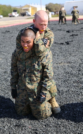 A recruit from Mike Company, 3rd Recruit Training Battalion, applies a choke hold during a Marine Corps Martial Arts Program test at Marine Corps Recruit Depot San Diego, July 20. The recruits test to earn a tan belt, which is the first level in the program, and they will continue to train and level up to earn the gray, green, brown and black belts later in their careers. Annually, more than 17,000 males recruited from the Western Recruiting Region are trained at MCRD San Diego. Mike Company is scheduled to graduate Aug. 12.