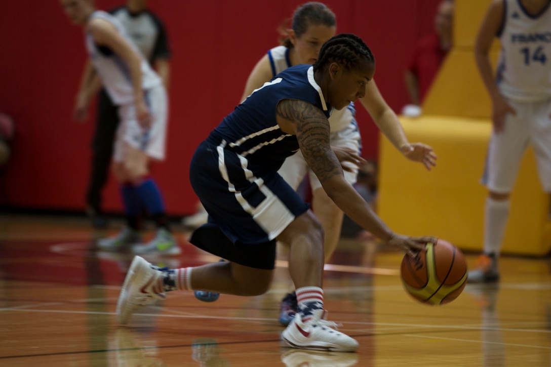 U.S. Army Sgt. Danielle Deberry, a guard on the United States Military Women’s Basketball Team, dribbles around a defender during United States vs. France game at the Conseil International Du Sport Militaire (CISM) World Military Women’s Basketball Championship July 26 at Camp Pendleton, California. The base is hosting the CISM World Military Women’s Basketball Championship July 25 through July 29 to promote peace activities and solidarity among military athletes through sports. (U.S. Marine Corps photo by Sgt. Abbey Perria)