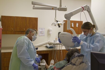 FORT THOMPSON, S.D. --  Spc. Samantha Davis, of the 7239th out of Chatanooga, works with civilian Dr. Velma Dennis to get a dental x-ray of a local patient at the Indian Health Center. Davis is one of six Soldiers from the 1207th U.S. Army Hospital, out of Fort Benning, Georgia that is performing Innovative Readiness Training at the IHC. IRT allows soldiers to use their Army skills in a real world experience.