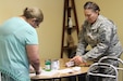 LOWER BRULE, S.D -- U.S. Army Reserve Maj. Elizabeth Rodriguez, chief nutritionist with the 1207th U.S. Army Hospital, helps a student prepare ingredients during a healthy cooking demonstration July 20, 2016. Rodriguez conducted the class during an Innovative Readiness Training mission on the Lower Brule Indian Reservation located 61 miles southeast of Pierre, S.D. IRT allows Soldiers to use their skill set in real-world environments that positively impact communities. Rodriguez used the session to teach locals about managing their diabetes through diet and nutrition. (U.S. Army Reserve photo by Spc. David Alexander) 