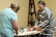 LOWER BRULE, S.D -- U.S. Army Reserve Maj. Elizabeth Rodriguez, chief nutritionist with the 1207th U.S. Army Hospital, helps a student prepare ingredients during a healthy cooking demonstration July 20, 2016. Rodriguez conducted the class during an Innovative Readiness Training mission on the Lower Brule Indian Reservation located 61 miles southeast of Pierre, S.D. IRT allows Soldiers to use their skill set in real-world environments that positively impact communities. Rodriguez used the session to teach locals about managing their diabetes through diet and nutrition. (U.S. Army Reserve photo by Spc. David Alexander) 