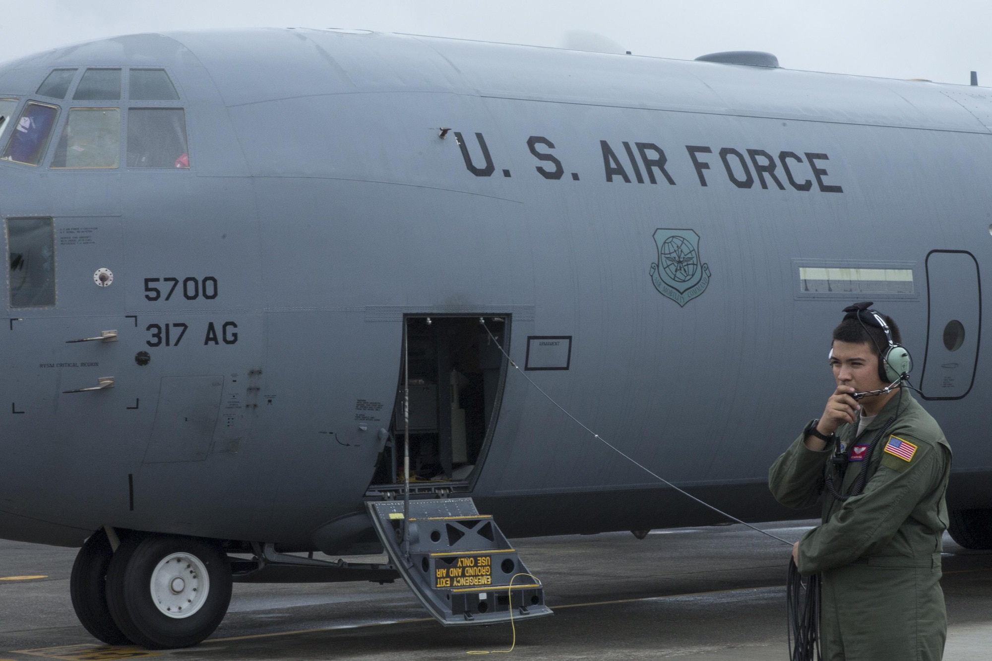 Airman 1st Class Marin Pina, 39th Airlift Squadron C-130J Super Hercules loadmaster, communicates with crew members at Yokota Air Base, July 21, 2016. Aircrews with the 39 AS from Dyess Air Force Base, Texas, traveled to Yokota to aid in transition from C-130 Hercules to the C-130J. (U.S. Air Force photo by Yasuo Osakabe/Released)