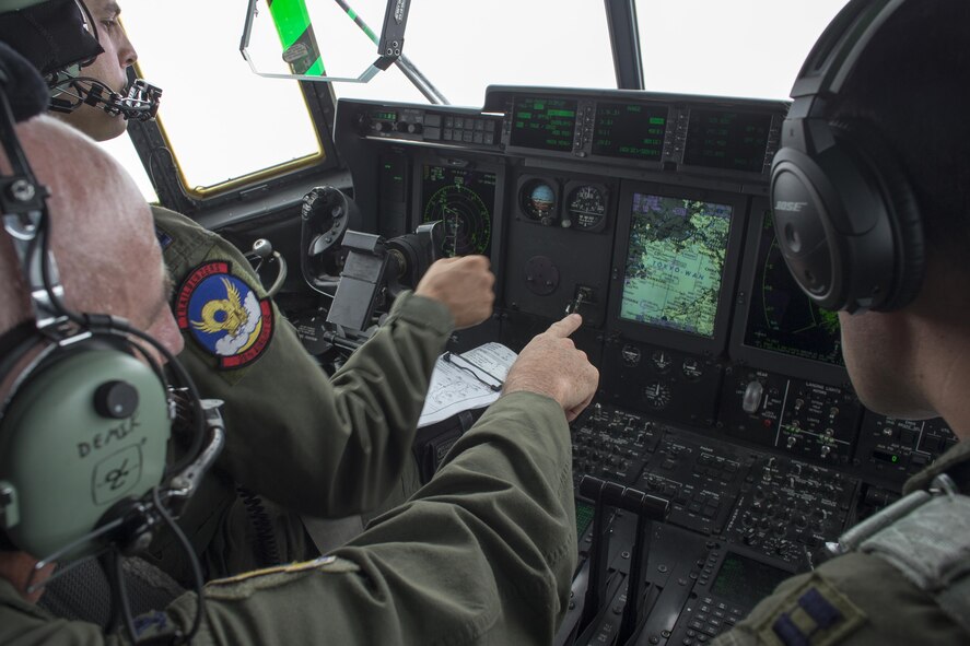 Col. Kenneth Moss, center, 374th Airlift Wing commander, checks a map on a display during a training flight over Tokyo Bay, July 21, 2016. Three C-130Js from Dyess Air Force Base, Texas, traveled to Yokota to aid in the transition from C-130 Hercules to C-130 Super Hercules. Fourteen C-130Js are scheduled to start replacing Yokota’s C-130Hs later this year, which have been in service since 1974. (U.S. Air Force photo by Yasuo Osakabe/Released)