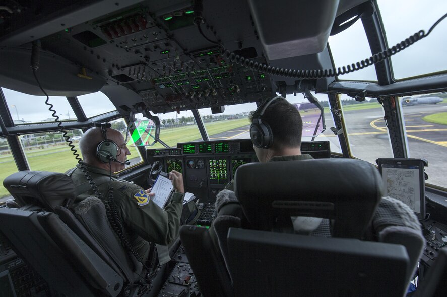 Col. Kenneth Moss, 374th Airlift Wing commander, and Capt. Michael McKenna, 39th Airlift Squadron C-130J Super Hercules pilot, perform checklists before takeoff at Yokota Air Base, Japan, July 21, 2016. Airmen with the 39 AS traveled from Dyess Air Force Base, Texas, to Yokota to aid in transitioning from the C-130 H to the J model. (U.S. Air Force photo by Yasuo Osakabe/Released)