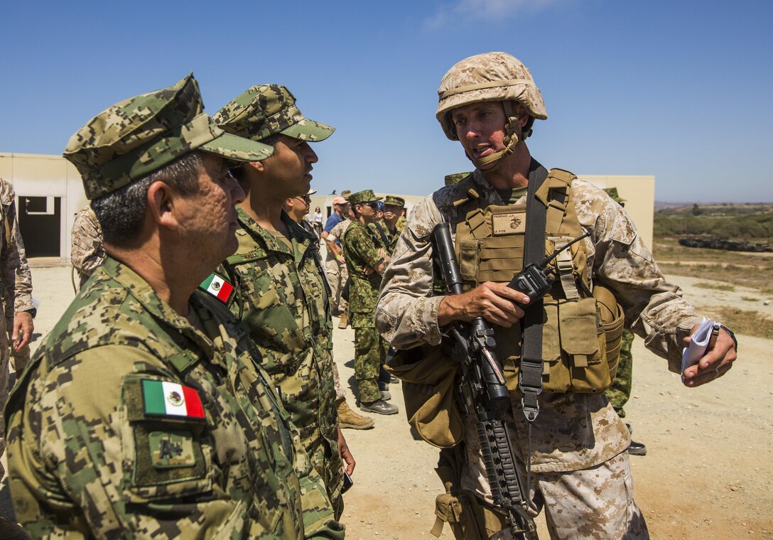 U.S. Marine Corps Capt. Johnathon Farrar, right, company commander of 1st Transportation Battalion, 1st Marine Logistics Group, speaks to Mexican Navy Vice Adm. Rafael Lopez Martinez, Marine Corps Coordinator General of the Mexican Secretariat of the Navy, about amphibious landing capabilities during USPACOM Amphibious Leaders Symposium (PALS) on Camp Pendleton, Calif., July 13, 2016. PALS brings together senior leaders of allied and partner nations from the Indo-Asia-Pacific region to discuss key aspects of maritime/amphibious operations, capability development, crisis response, and interoperability. Twenty-two allied and partnered nations, including the U.S. are participating. (U.S. Marine Corps photo by Cpl. Wesley Timm/Released)