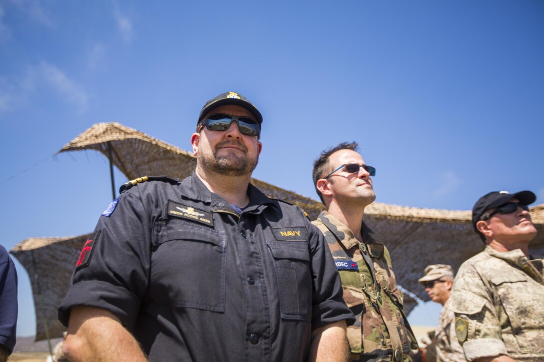 Royal New Zealand Commander Simon Rooke, commanding officer of HMNZ Canterbury, observes an amphibious landing demonstration during USPACOM Amphibious Leaders Symposium (PALS) on Camp Pendleton, Calif., July 13, 2016. PALS brings together senior leaders of allied and partner nations from the Indo-Asia-Pacific region to discuss key aspects of maritime/amphibious operations, capability development, crisis response, and interoperability. Twenty-two allied and partnered nations, including the U.S. are participating. 