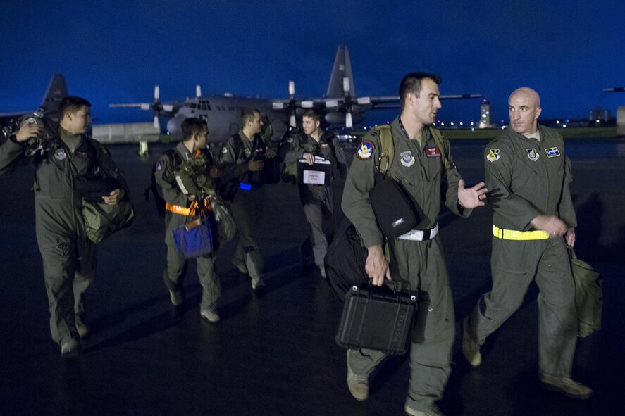 Crew members with the 39th Airlift Squadron and Col. Kenneth Moss, right, 374th Airlift Wing commander, exit the flightline after completing a training flight at Yokota Air Base, Japan, July 21, 2016. Three C-130J Super Hercules from Dyess Air Force Base, Texas, traveled to Yokota to aid in transition from C-130Hs to C-130Js. Fourteen C-130Js are scheduled to start replacing Yokota’s C-130Hs later this year, which have been in service since 1974. (U.S. Air Force photo by Yasuo Osakabe/Released) 