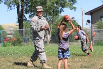 LOWER BRULE, S.D.—Spc. Jesus Ortiz, a behavioral health specialist from the Army Reserve 7239th Medical Support Unit based in Chattanooga, Tenn., plays football with local kids from the Lower Brule Indian Reservation located 61 miles south of Pierre, S.D. July 19, 2016. Ortiz visited the Boys and Girls Club there during an Innovative Readiness Training mission on the reservation. IRT allows Ortiz to use his skill set to better understand the needs of local children. (U.S. Army Reserve photo by Spc. David Alexander) 
