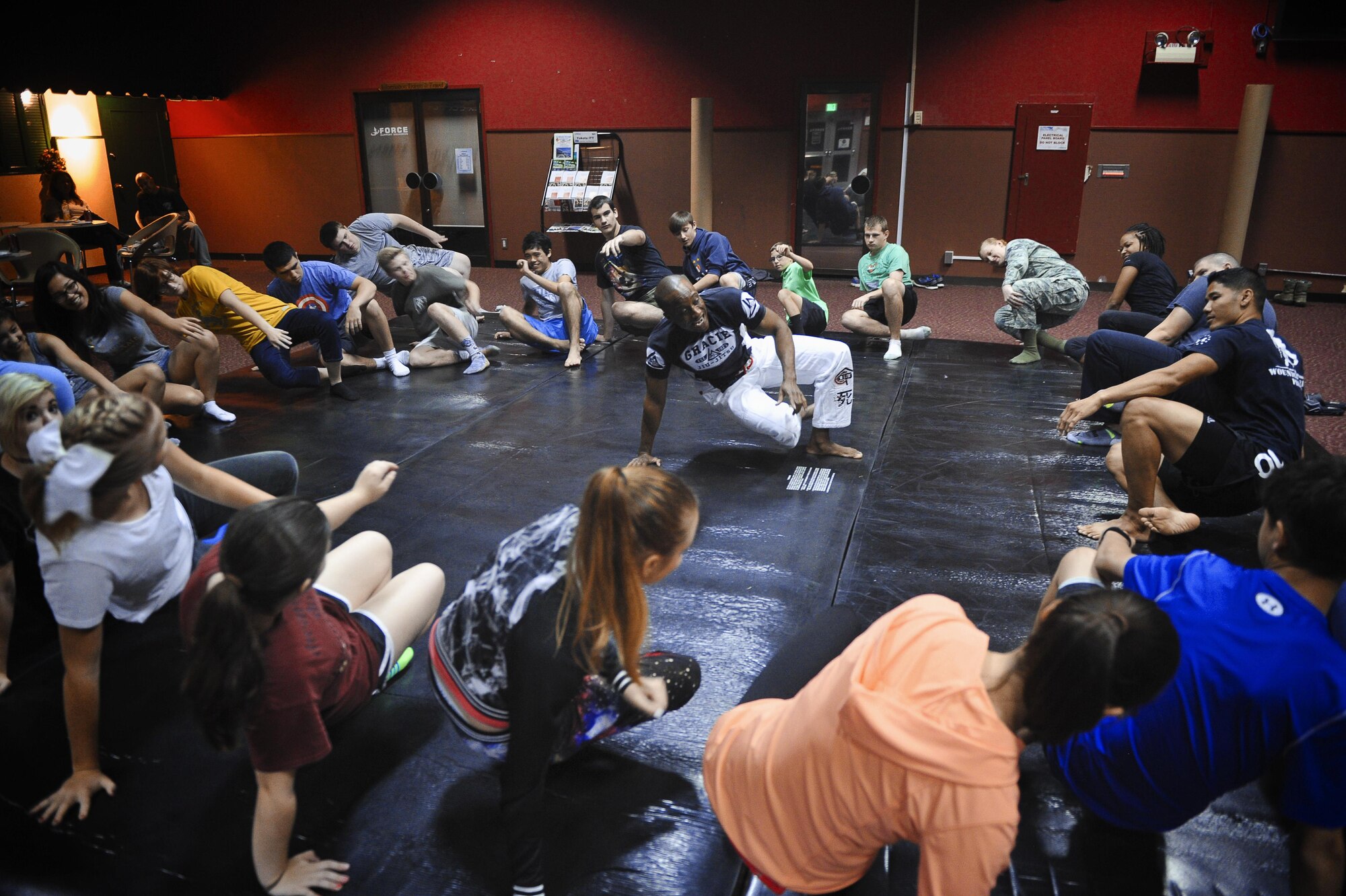 Maj. Tyrone Bess, 374th Security Forces Squadron commander, demonstrates how to properly stand from a seated position during a Gracie Jiu-Jitsu Defense Systems course at Yokota Air Base, Japan, July 23, 2016. The Gracie Defense Systems is a program specifically designed to increase awareness and reduce the frequency of sexual assaults. (U.S. Air Force photo by Senior Airman Delano Scott/Released)