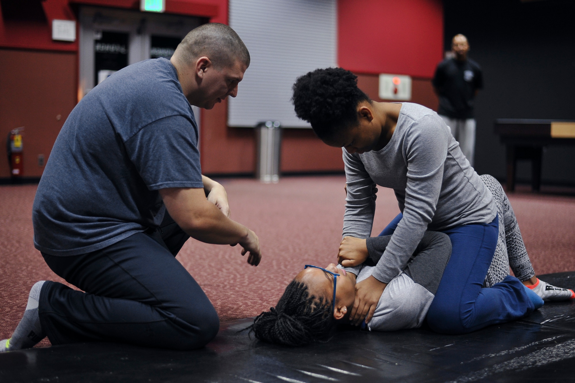 Tech Sgt. Michael Hilton 374th Aircraft Maintenance Squadron NCO in-charge, explains to participants how to get out of a simulated chokehold during a Gracie Jiu-Jitsu Defense Systems course at Yokota Air Base, Japan, July 23, 2016. The course teaches 15 self-defense techniques to students that will make them hard targets against a sexual assault perpetrator in real life situations. (U.S. Air Force photo by Senior Airman Delano Scott/Released)